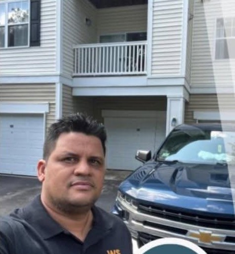 Watson, owner of WS Painting, in front of a freshly finished Massachusetts home