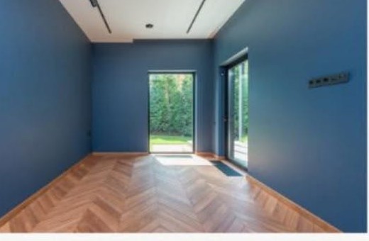 Interior room painted in a deep blue with crisp white ceiling